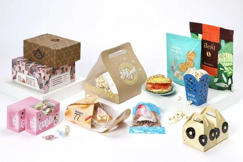 Custom food and beverages packaging including snack boxes, popcorn holders, candy cartons, bakery trays, and printed stand-up pouches