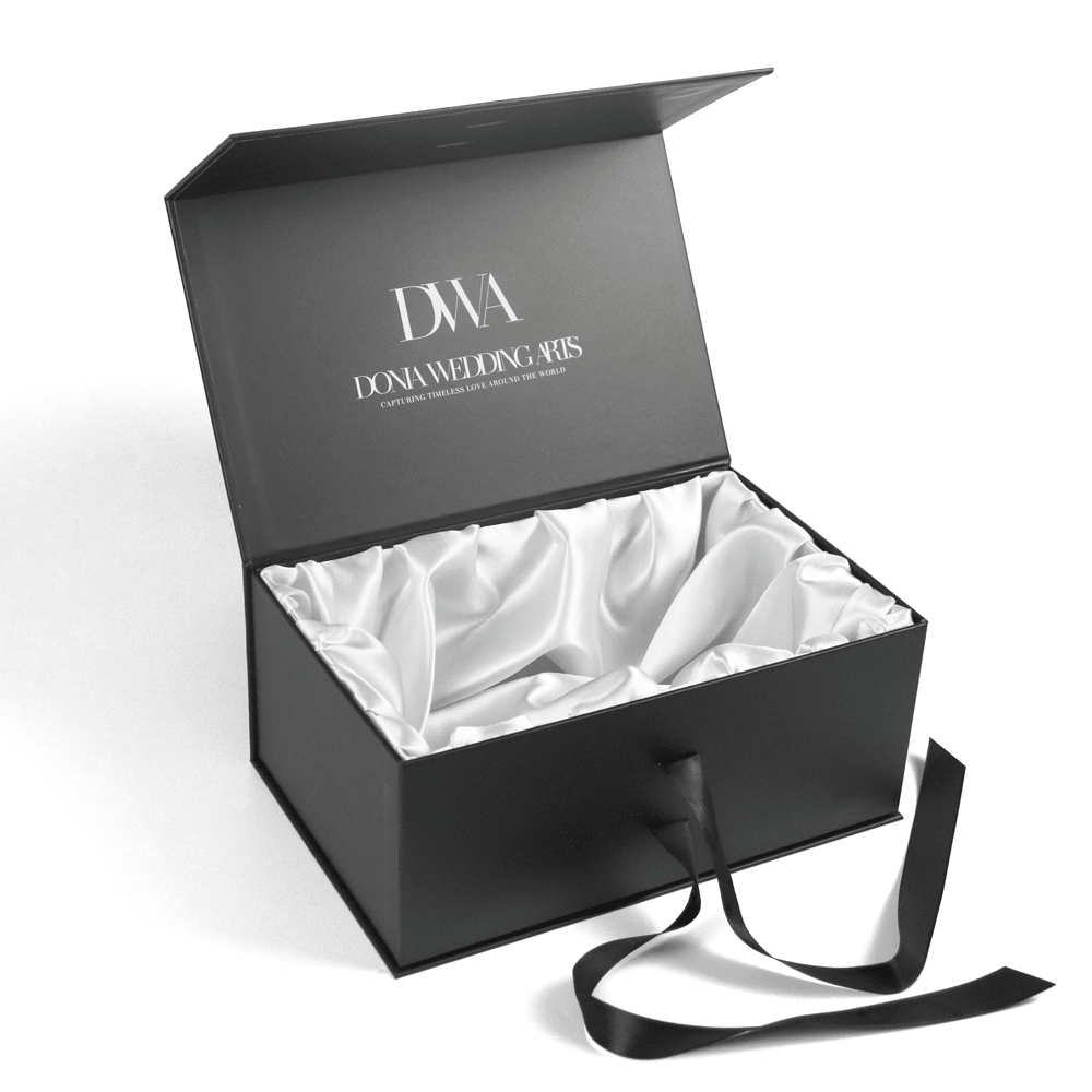 Luxury black magnetic gift box with ribbon closure and white satin lining, ideal for premium wedding or jewelry packaging.