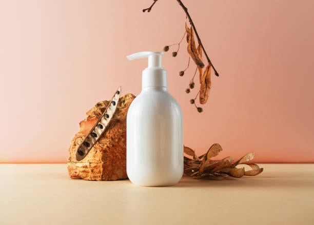 Minimalist white soap pump bottle styled with natural elements for eco-friendly product presentation