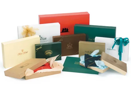 Collection of luxury gift boxes with tissue wrap and branded labels for upscale clothing packaging