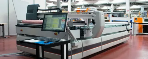 Large-scale digital die cutting system with control panel in industrial setting