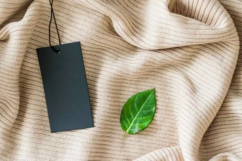 Minimalist clothing tag and leaf symbolizing sustainable fashion design