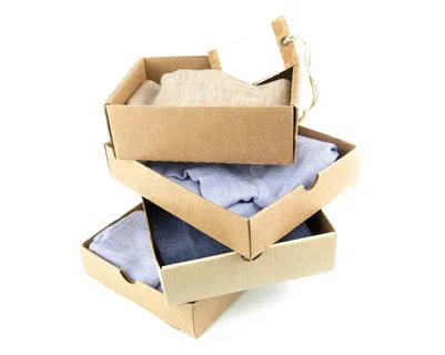 Set of stacked kraft boxes containing folded garments for sustainable clothing packaging