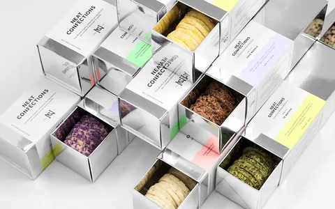 Luxury cookie packaging in metallic sliding boxes.