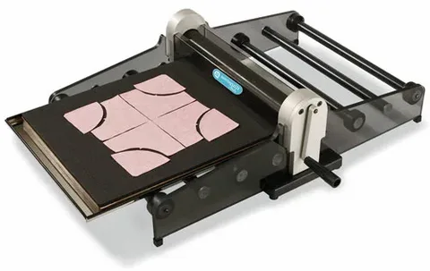 Compact tabletop die cutting machine cutting fabric into custom rounded shapes