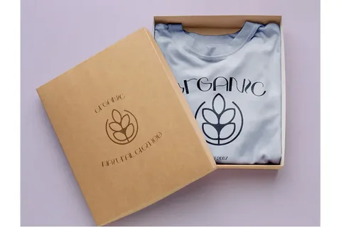 Folded organic cotton T shirt in kraft box featuring custom eco brand design