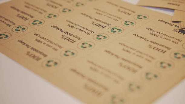 Close-up of recycled paper labels with green recycling icons for sustainable packaging