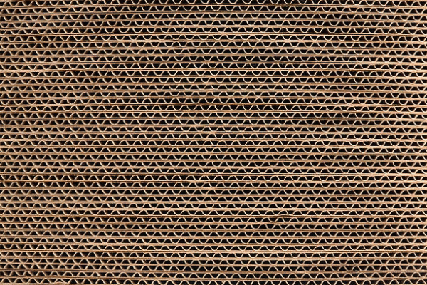 Detailed view of corrugated cardboard material with visible flutes