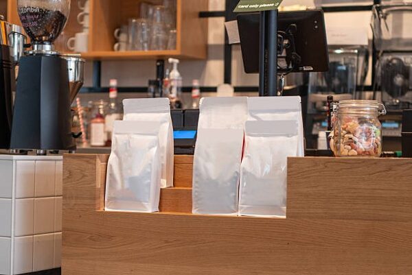 Coffee packaging bags arranged neatly on a café counter for retail display.
