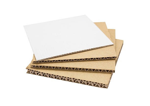 Stack of corrugated sheets with top white coating, demonstrating liner options for printed packaging.