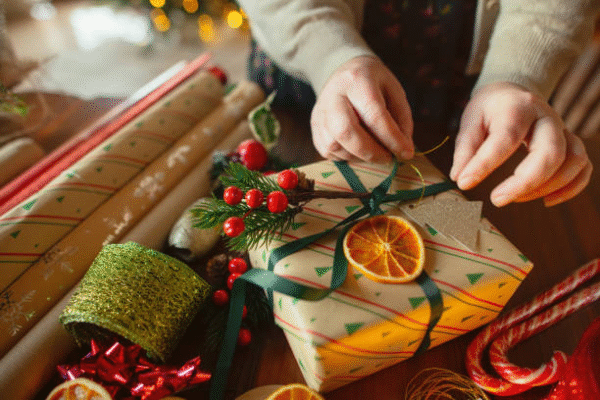 Festive DIY small business packaging wrapped with ribbon and natural decoration for holiday gifts.
