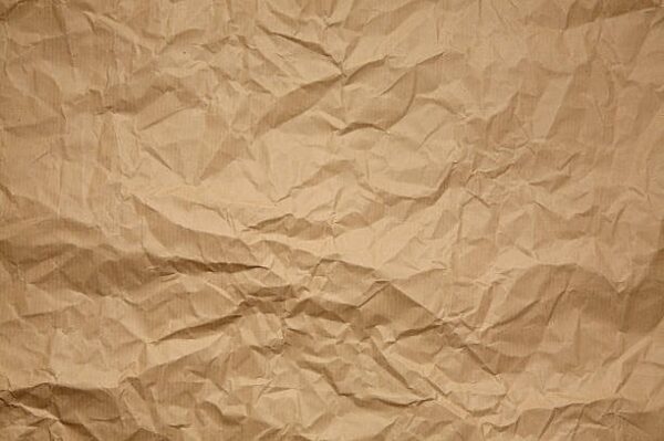 Crumpled kraft paper texture showing the natural brown fiber surface.