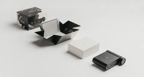Minimalist electronic packaging with black and white geometric design and clean product presentation.
