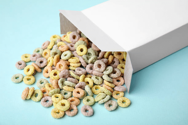Open cereal box packaging with colorful cereal rings inside.