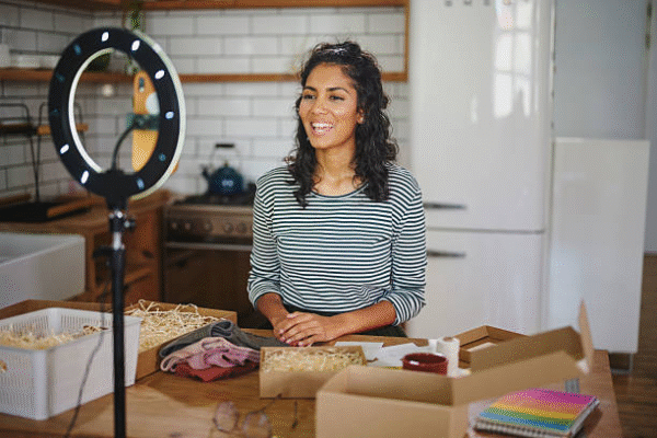 Small business owner creating video content about DIY packaging and unboxing ideas.