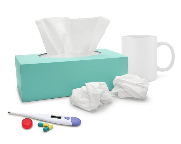 Tissue box alongside medicine and thermometer showing bad packaging design in healthcare setting