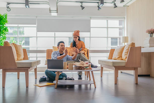 Two people organizing apparel packaging and checking product details before shipping.
