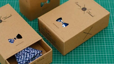 Bow tie boxes with window sleeve packaging showing product visibility and branding.