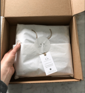 Apparel wrapped in paper inside a recyclable box, reflecting clean and eco-friendly packaging for green fashion brands.