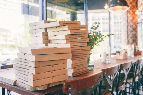 Piles of pizza boxes showing different pizza box dimensions