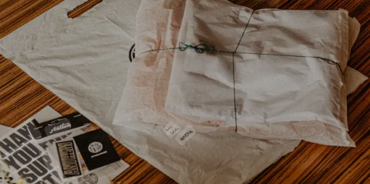 Eco-friendly apparel packaging setup with paper wraps and recyclable inserts used by sustainable fashion brands.