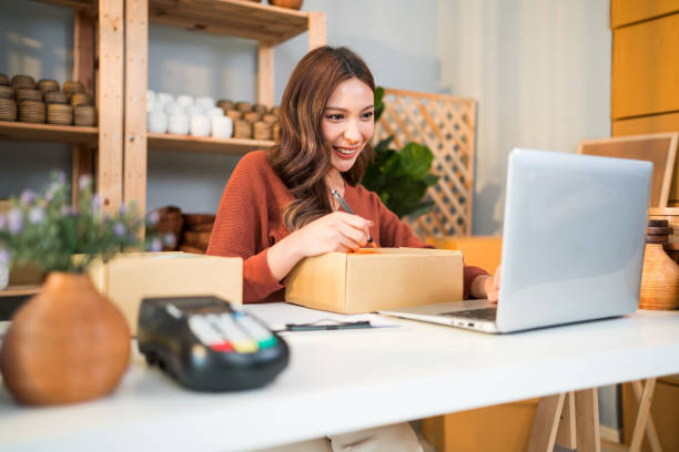 E-commerce seller managing packaging and order preparation for clothing brand.