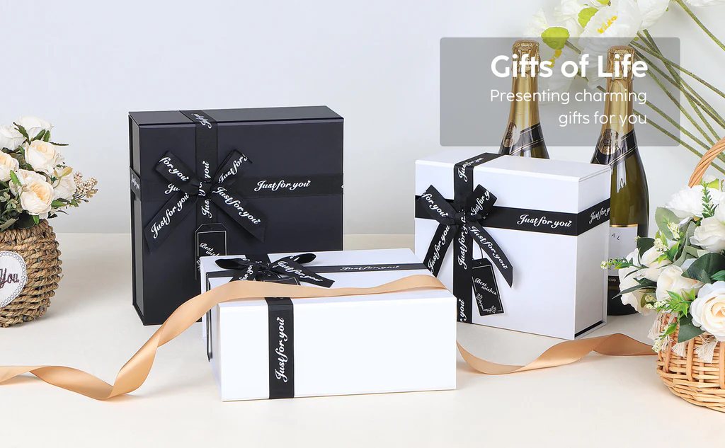 Black and white gift boxes with satin ribbons and thank-you cards arranged on a styled table with flowers and decor. These customizable packaging solutions enhance brand storytelling and customer loyalty.