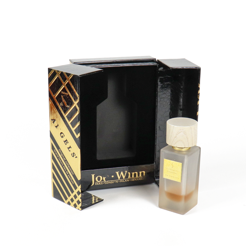 Black glossy box with gold diagonal stripes and transparent window, housing a frosted glass perfume bottle—representing high-end cosmetic packaging where visual impact outweighs FSC labeling.