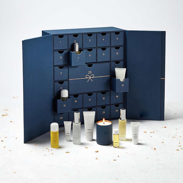 Deep blue rigid box with 25 numbered drawers, each containing a small skincare product—ideal for limited-edition cosmetic packaging requiring high MOQ due to complex structure.