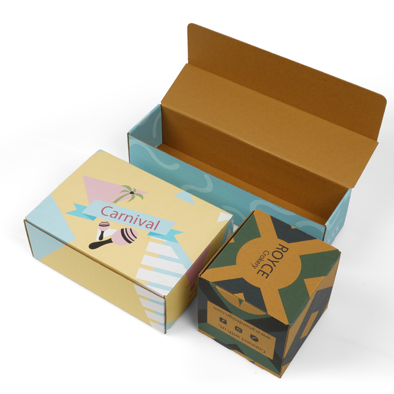 Colorful custom corrugated boxes with "Carnival" and "ROYCE" branding, one open to show blue interior lining—ideal for branded aftermarket automotive components.