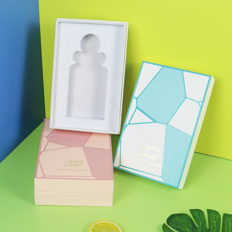 Colorful rigid boxes with geometric patterns and perfume bottle-shaped cutouts—demonstrating creative cosmetic packaging that prioritizes design over FSC certification.