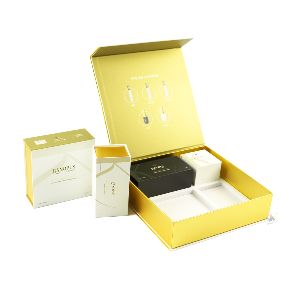 Shiny gold rigid box with white interior compartments and illustrated usage guide on lid, designed as high-end cosmetic packaging for professional skincare systems.