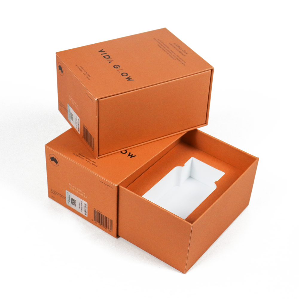 Matte orange rigid box with clean typography and white internal insert, showcasing minimalist luxury cosmetic packaging that emphasizes tactile quality and brand clarity.