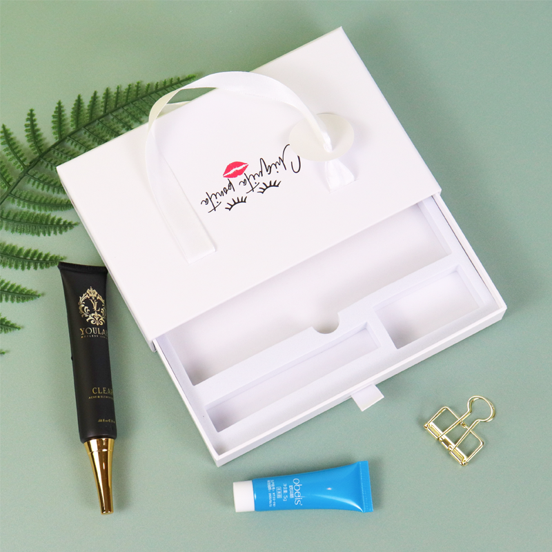 White rigid box with handle and lip print logo, featuring internal compartments for skincare products—ideal for travel kits or multi-product beauty sets.