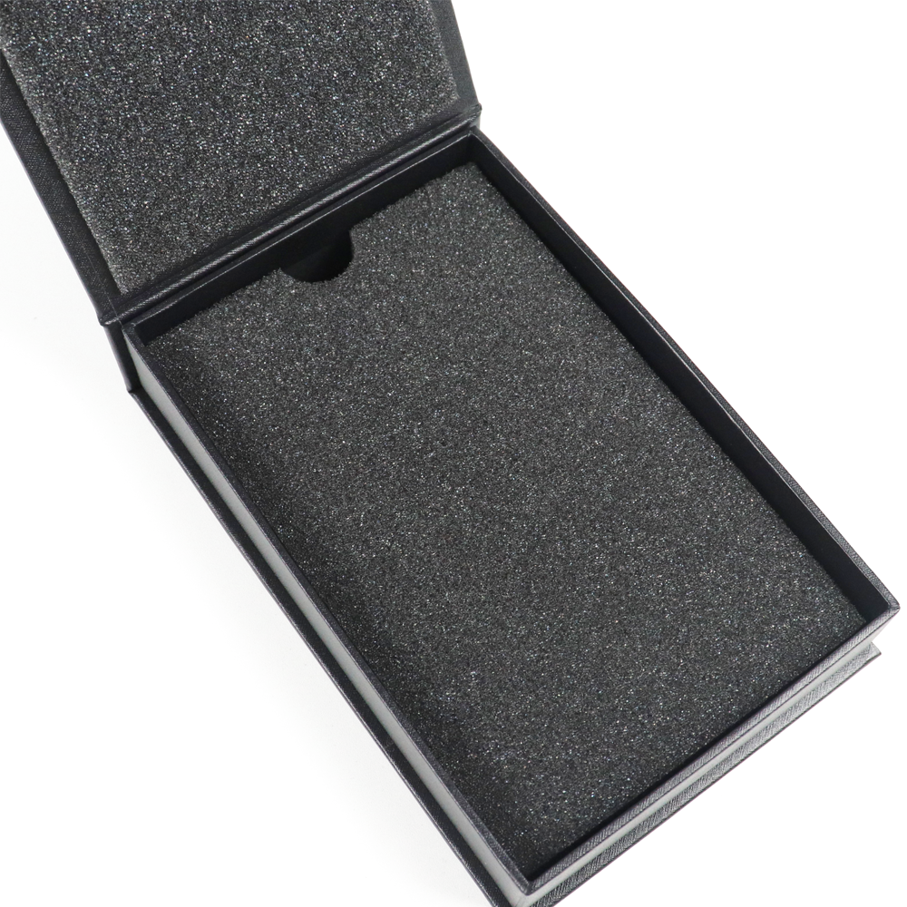 Custom black EVA foam insert with single cavity, designed for high-end apparel packaging with metal fasteners.
