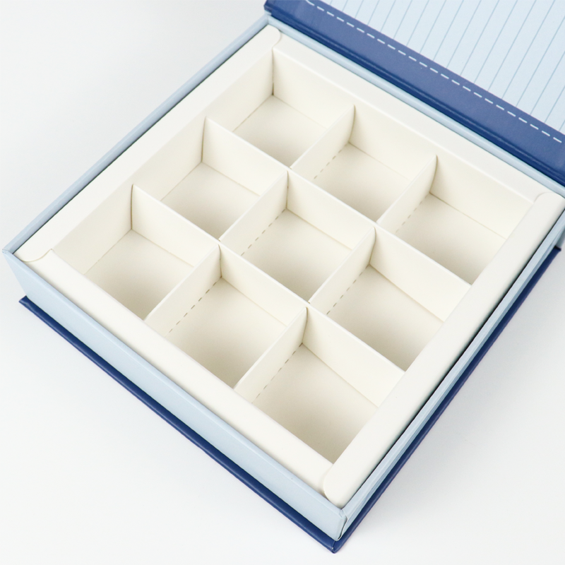White paperboard compartment insert with nine sections, ideal for organizing small apparel accessories in eco-friendly packaging.