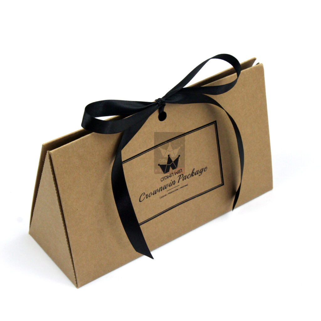 A minimalist brown kraft paper pyramid-shaped gift box tied with a black satin ribbon, ideal for sustainable fashion brands or eco-conscious product lines.