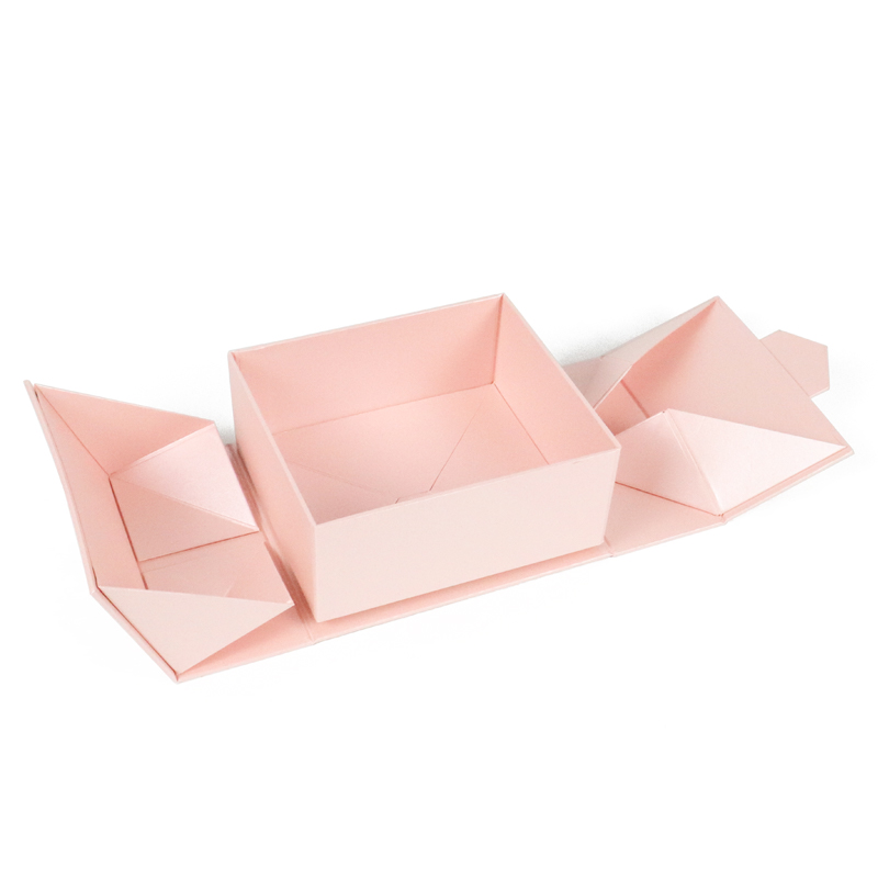 A flat-packed pink origami-style box shown in its unfolded state—representing innovative, low-waste packaging design that reduces shipping volume and carbon footprint, ideal for e-commerce and sustainable apparel packaging strategies.