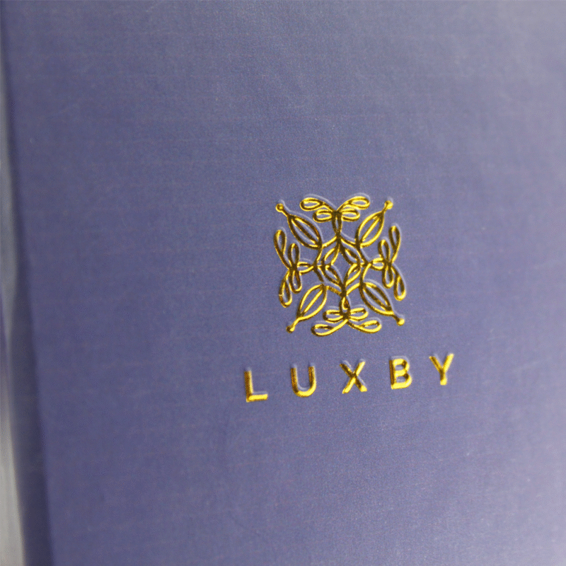 Blue packaging box with a gold foil logo and Spot UV coating, combining metallic sheen with glossy highlights for maximum brand visibility and tactile appeal in luxury packaging.