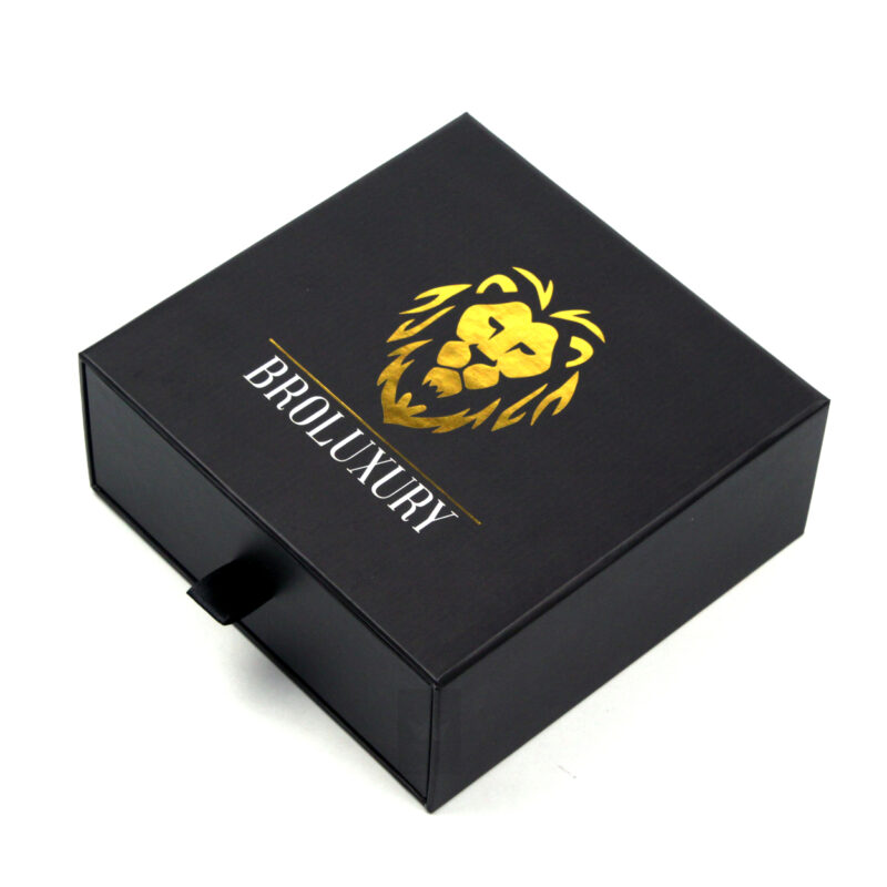 Black rigid box with a golden lion logo and "BROLUXURY" text using hot stamping, creating a striking contrast and premium feel suitable for high-end consumer goods.