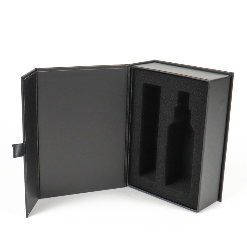 A sleek black rigid box with a magnetic closure and custom-cut foam insert designed to securely hold two bottles—demonstrating precision engineering and protective luxury packaging that emphasizes exclusivity and brand refinement.
