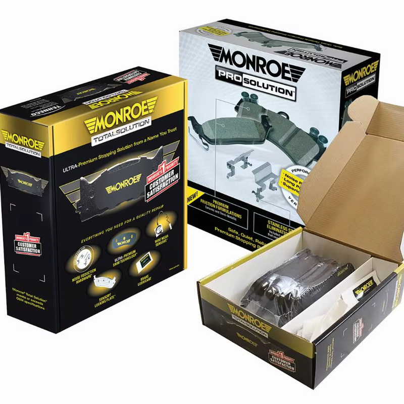 Open Monroe brake pad packaging showing black pads secured with white foam inserts—demonstrating real-world use of cushioning materials in automotive parts.