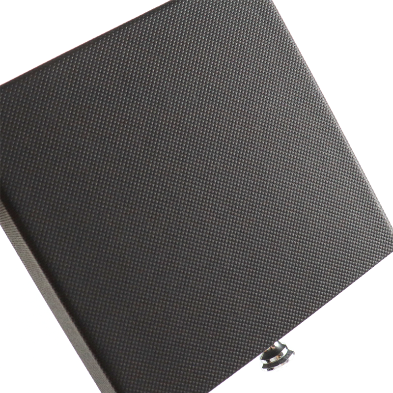 Close-up of a black rigid box featuring a fine dot pattern texture, showcasing a minimalist blind embossing technique that enhances tactile quality without added color or foil.