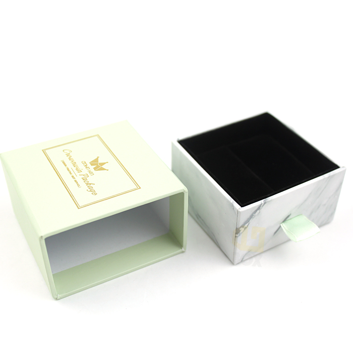Light green and marble-textured drawer box with gold logo and "Crownwin Package" text, open to reveal black interior, showcasing elegant design and functional features.