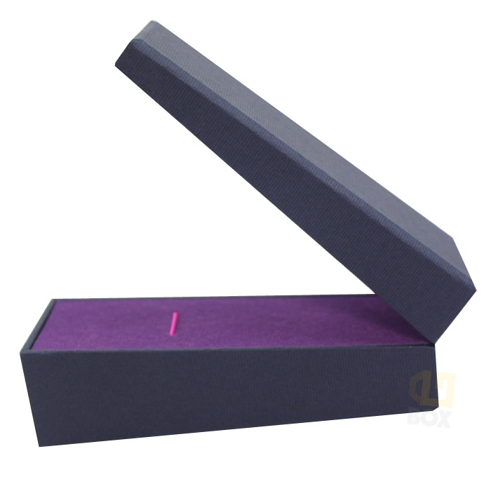 Dark blue box with purple velvet interior and pink accent line, open to reveal protective insert, showcasing high-end finish and structural integrity.
