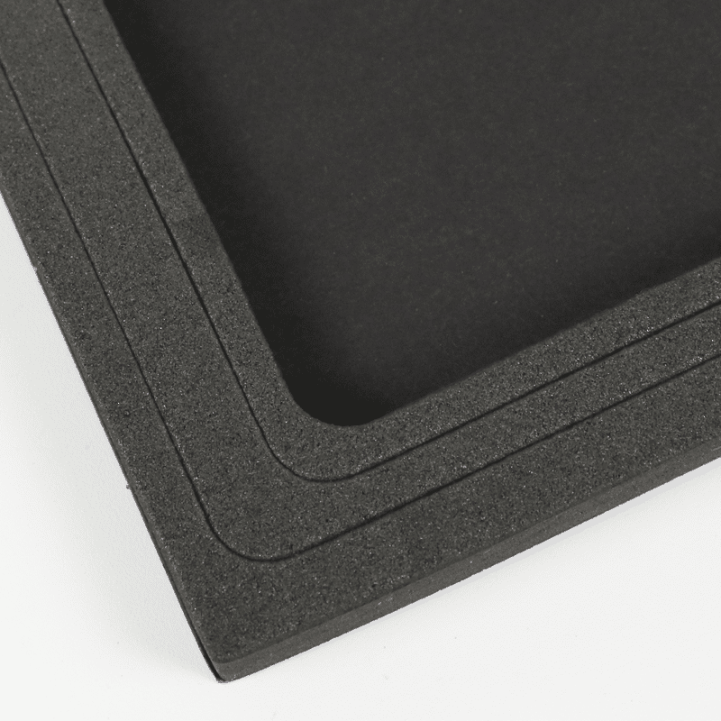 Stack of black EVA foam inserts with rounded corners, showcasing uniform thickness and tight tolerances for reliable manufacturing.