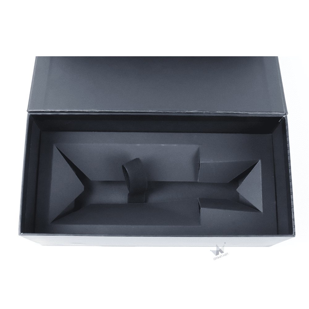 Top-down view of a black paperboard inner tray with die-cut compartments and central support, designed to hold multiple wine bottles securely.