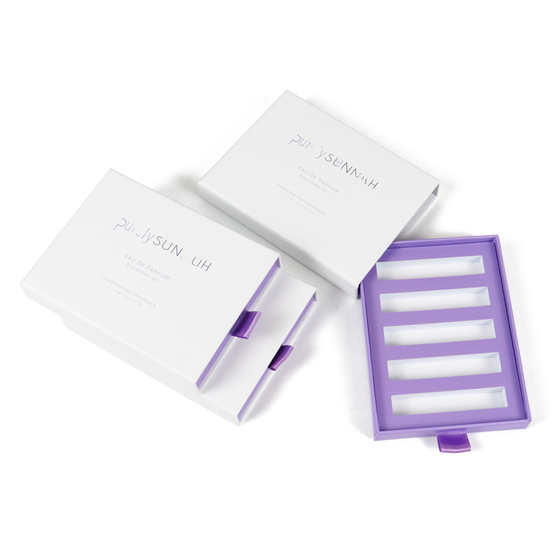 White rigid drawer box with purple interior and cut-out compartments, featuring clean typography and precise alignment for premium product presentation.