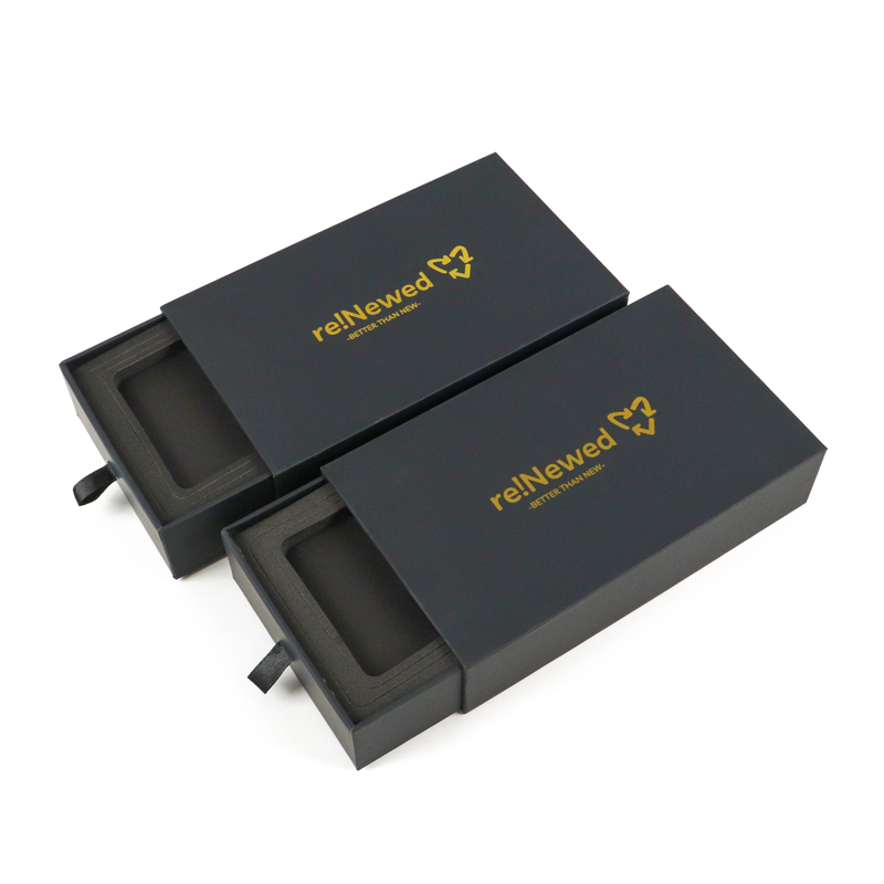 Black matte rigid drawer box with gold foil logo "re!Newed" and pull-tab handle, featuring a clean, minimalist design ideal for high-end vape packaging.