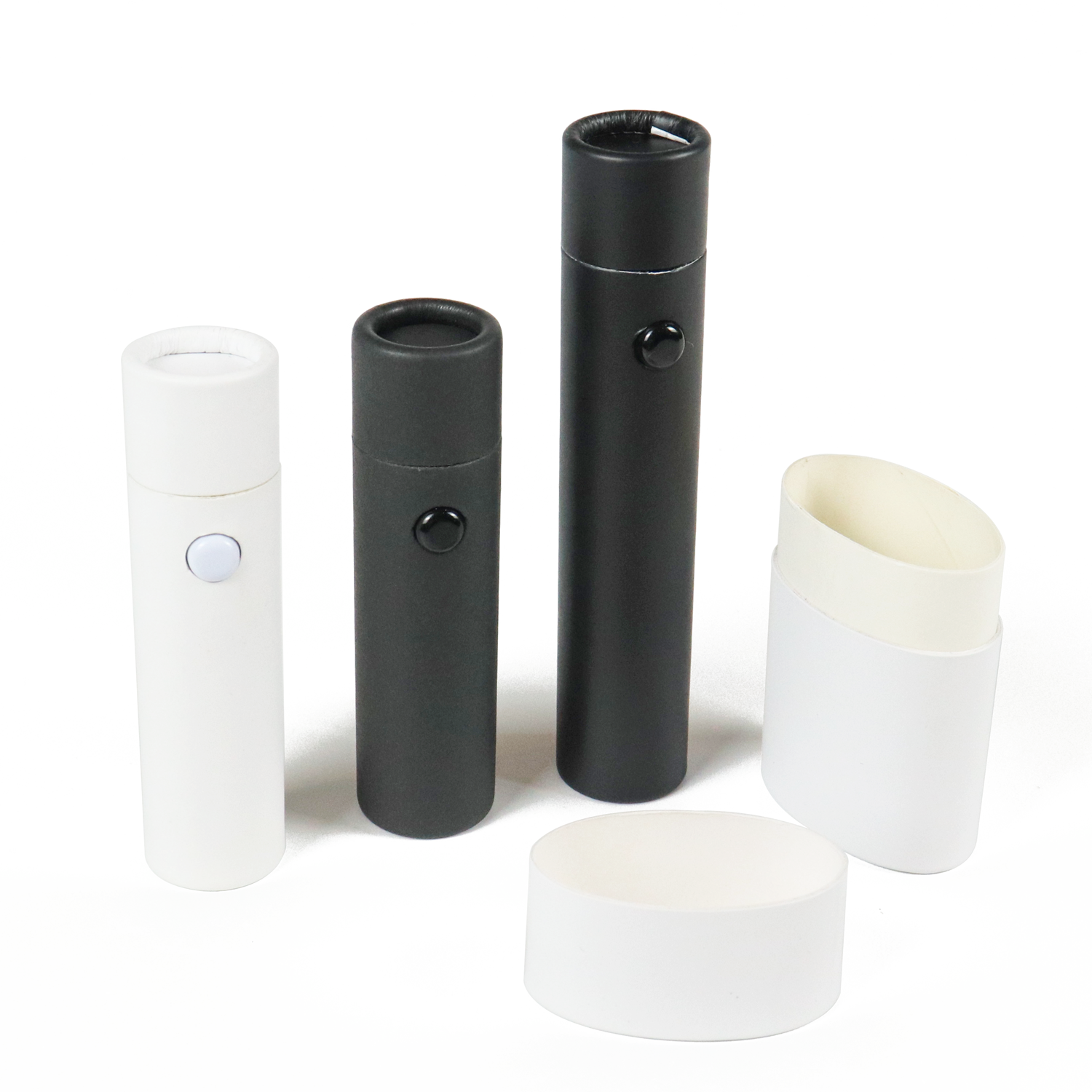 Set of white and black cylindrical paperboard tubes with magnetic snap closures, varying in size, showcasing durable custom vape packaging designed for high-performance retail and logistics environments.